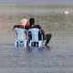 A Sudanese couple enjoy the shallow waters of the Nile River in Khartoum, Sudan, April 24, 2019.